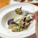 Tasty meat meal, a woman eating with a fork